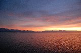 mare romantico al tramonto con montagne in lontananza